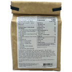 Back side of a kraft paper bag showing a nutrition facts label for Superfine Brown Rice Flour 3lbs, with a brown paper roll partially visible behind it on a white background.